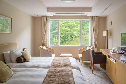 Postel nebo postele na pokoji v ubytování Nasu Kasumigajo Hotel & Resort