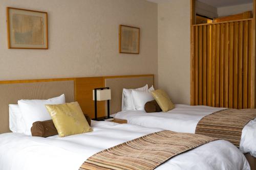 Postel nebo postele na pokoji v ubytování Nasu Kasumigajo Hotel & Resort