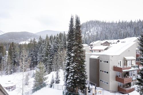 a ski lodge in the snow with trees at Iron Horse C5083 condo in Winter Park