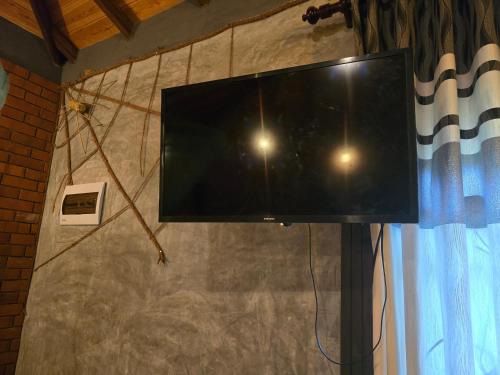 a flat screen tv hanging on a wall at Ceylon Resort Wilpattu in Wilpattu
