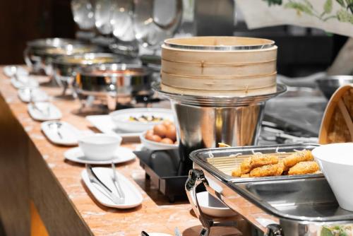 a buffet line with dishes of food on a table at Northharbor Hotel in Busan