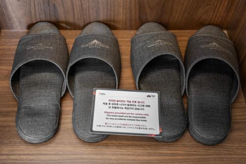 a group of three pairs of shoes with a thermometer at Northharbor Hotel in Busan