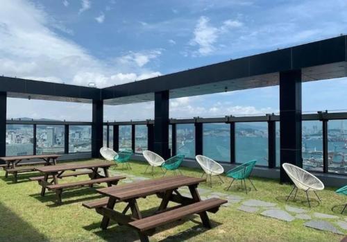 a group of picnic tables and chairs on the roof of a building at Northharbor Hotel in Busan
