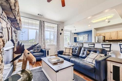 a living room with a blue couch and a kitchen at 152 Ponds on the Blue River home in Silverthorne
