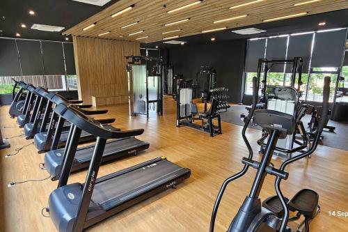 a gym with a row of treadmills and machines at Mimpi Muji Gamuda Cove in Pulau Kempas