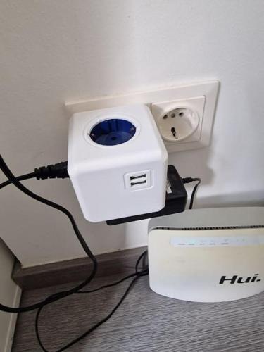 a white box is plugged into a wall at Appartement City Center in Vienna