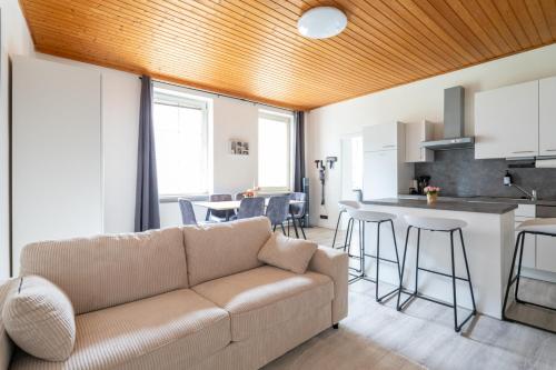 a living room with a couch and a kitchen at COY Apartments Leoben - Stay Comfortable & Work Smart in Leoben