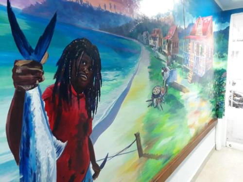 a mural of a black man standing on a beach at Hospedaje Belleza Isleña habitaciones Individuales in San Andrés