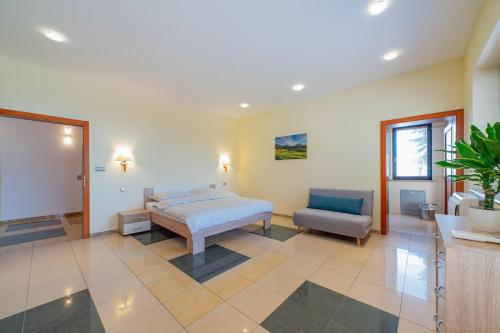 a bedroom with a bed and a chair at Raca Retreat in Rača