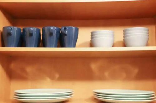 a shelf with white plates and bowls on it at S1 Private Kintex Daehwadong in Goyang