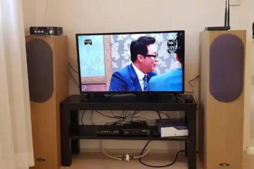 a flat screen tv sitting on a stand with speakers at S1 Private Kintex Daehwadong in Goyang