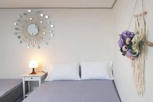 a bedroom with a bed and a mirror on the wall at S2 Private Kintex Daehwadong in Goyang