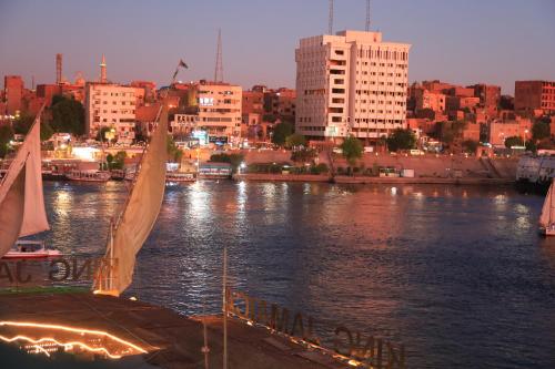 a view of a river with a city and buildings at Jamaica Guest House in Aswan