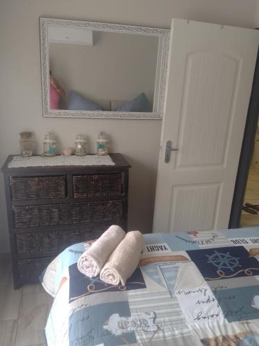 a bedroom with two towels on a bed and a mirror at eagles inn in Richards Bay