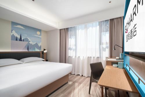 Ένα ή περισσότερα κρεβάτια σε δωμάτιο στο Echarm Hotel Sanya Haitang Bay Wuzhizhou Island Branch