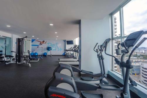 a gym with treadmills and ellipticals in a building at Wyndham Guayaquil, Puerto Santa Ana in Guayaquil