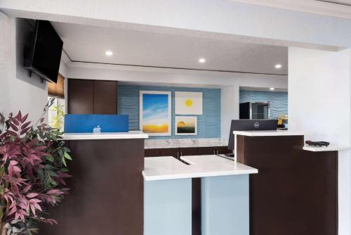 an office with a reception desk with a tv at Days Inn by Wyndham Miami in Miami