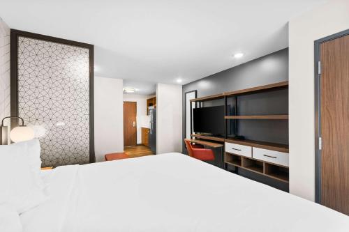 a hotel room with a bed and a flat screen tv at Everhome Suites Lexington - Horse Park in Lexington