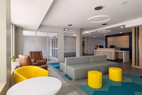 a lobby with a couch and chairs and a table at Microtel Inn & Suites by Wyndham Lachute in Lachute