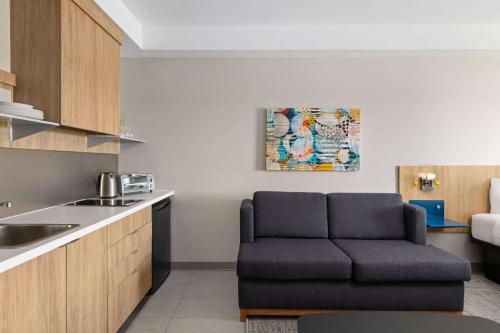 a living room with a couch in a kitchen at Microtel Inn & Suites by Wyndham Lachute in Lachute