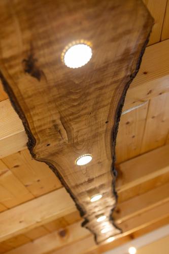 a wooden ceiling with a light on it at Camping Camplani in Zone