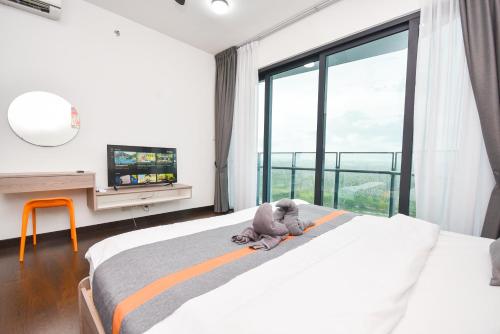 a teddy bear sitting on a bed in a bedroom at Almas Suite by Nest Home【Puteri Harbour & LEGOLAND】 in Nusajaya