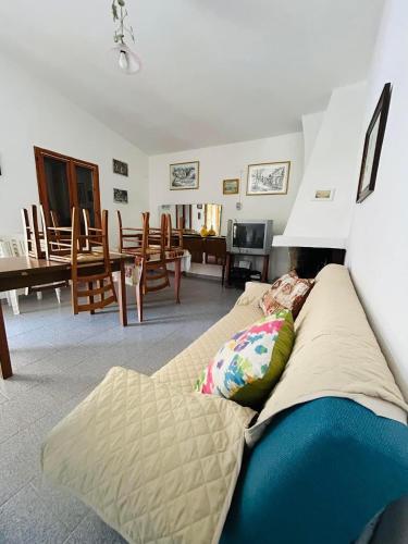 a living room with a couch and a dining room at Casa EMMID in Tertenìa