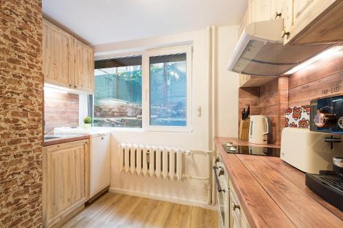 a kitchen with a counter top and a window at Stylish apartment, Top center! in Sofia