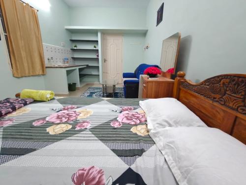 a bedroom with a bed with flowers on it at Maison Douce in Chennai