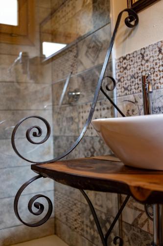 a bathroom with a shower with a bowl on a table at Camping Camplani in Zone
