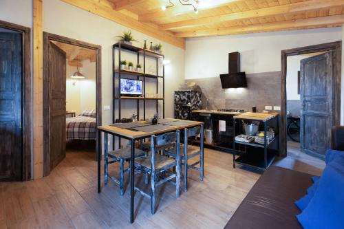 a living room with a table and a bedroom at Camping Camplani in Zone
