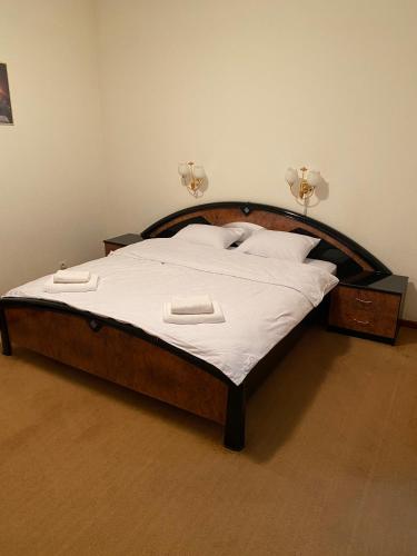 a bed with white sheets and pillows in a bedroom at Момент in Yuzhnoukrainsk 