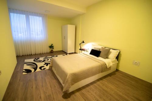 a bedroom with a large bed and a window at Oasis in Struga