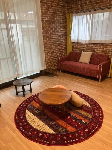 a living room with a couch and a table at いわしの子守唄 Sardine Lullaby in Matsuyama