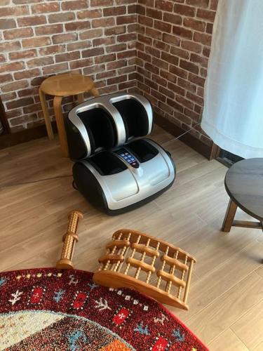 a toaster sitting on the floor in a living room at いわしの子守唄 Sardine Lullaby in Matsuyama
