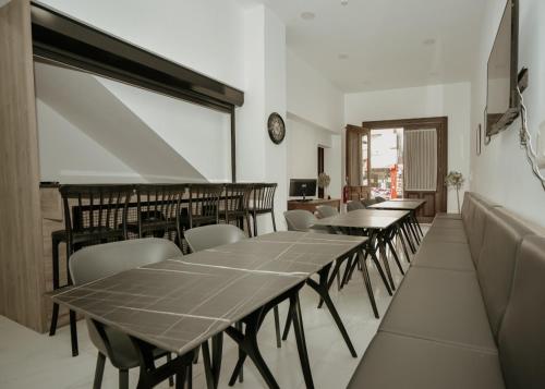 a room with tables and chairs and a clock on the wall at Old Stone Boutique Hotel in North Nicosia