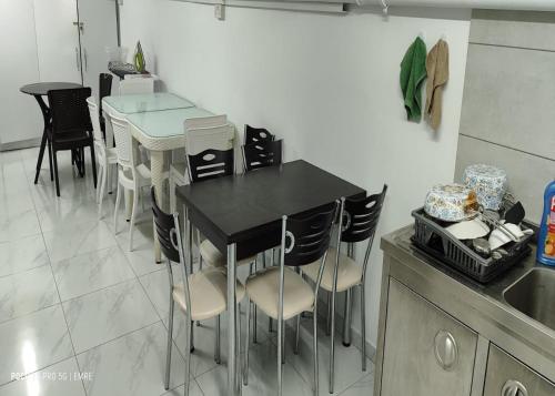 a kitchen with a black table and some chairs at Old Stone Boutique Hotel in North Nicosia