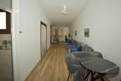 a waiting room with blue chairs and a table at Old Stone Boutique Hotel in North Nicosia