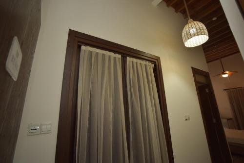 a bathroom with a shower curtain and a mirror at Old Stone Boutique Hotel in North Nicosia