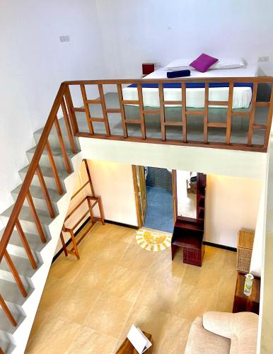 a room with a bunk bed and a staircase at Maccan's Village in Arugam Bay