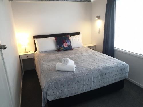 a bedroom with a bed with a towel on it at Little Haven in Taupo