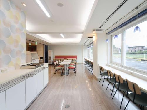 a kitchen and dining room with a table and chairs at Comfort Inn Tosu in Tosu
