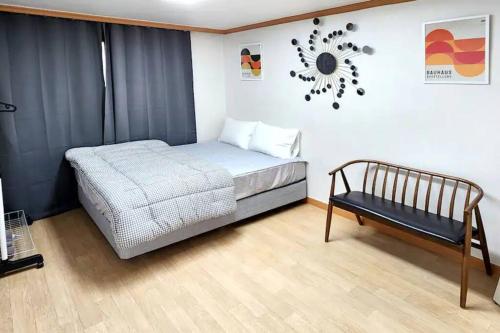 a bedroom with a bed and a clock on the wall at S3 Private Kintex Daehwadong in Goyang