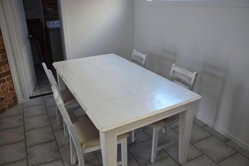 a white table and chairs in a room at High 5 in South West Rocks