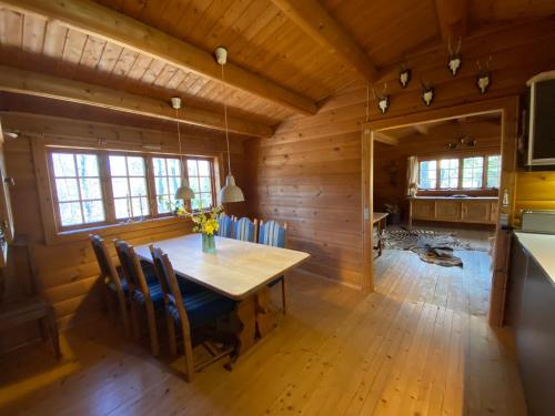 a dining room with a table in a cabin at Log-House Wildernest in Brande
