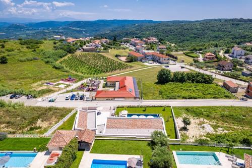an aerial view of a villa with a pool and a resort at Villa Andrea in Vižinada