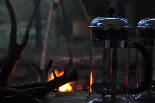 a lantern sitting next to a fire at Log-House Wildernest in Brande