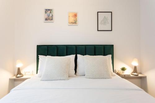 a bedroom with a large white bed with white pillows at Modern City Residences - Free Private Parking in Zagreb