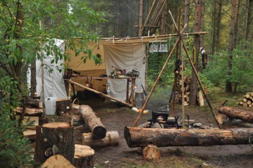 a tent in the middle of a forest with logs at Log-House Wildernest in Brande