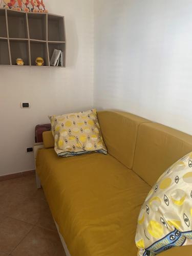a couch with two pillows on it in a room at Piccolo Paradiso in Praia a Mare in Praia a Mare